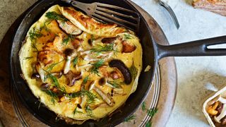 A wild mushroom omelet cooking in a pan