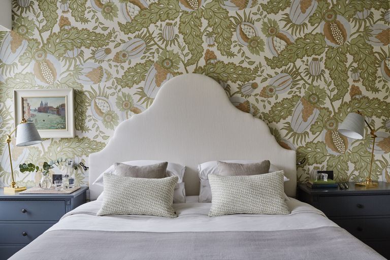 Green and cream plant wallpaper, cream bedhead, blue bedside tables