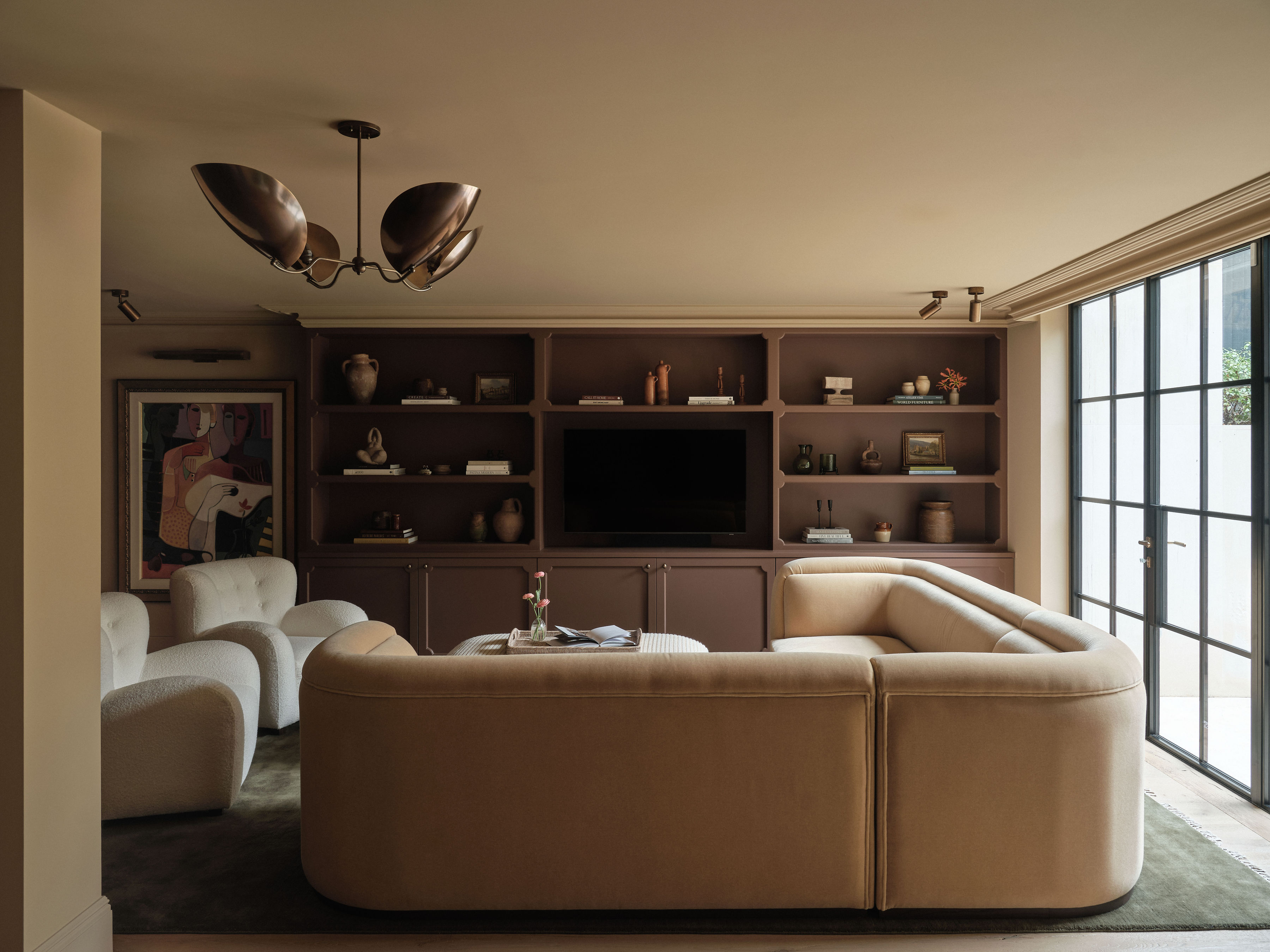 A pale brown velvet corner sofa in a contemporary living room
