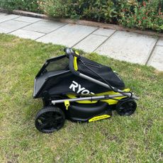 Ryobi ONE+ lawnmower folded on grass