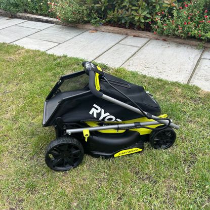 Ryobi ONE+ lawnmower folded on grass