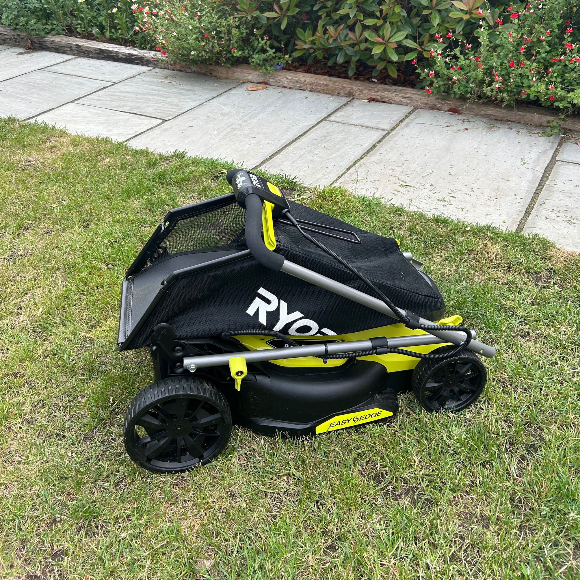 Ryobi ONE+ lawnmower folded on grass
