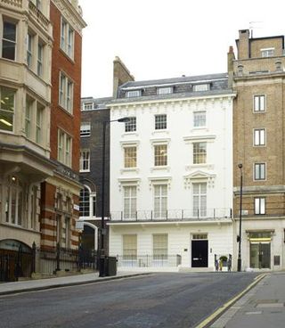 Colour photograph of Grafton Street, London, showing the front of the white four-storey art gallery sandwiched between two buildings with darker brick.