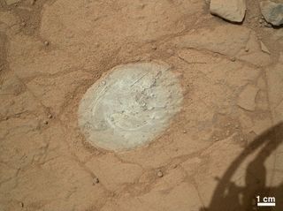 This image from NASA's Mars rover Curiosity shows the patch of rock cleaned by the first use of the rover's Dust Removal Tool on Jan. 6, 2013.