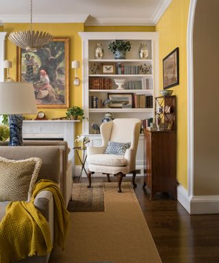 Yellow living room, cream armchair, rug