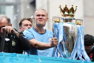 Erling Haaland celebrates with the Premier League trophy after Manchester City's success in 2023/24