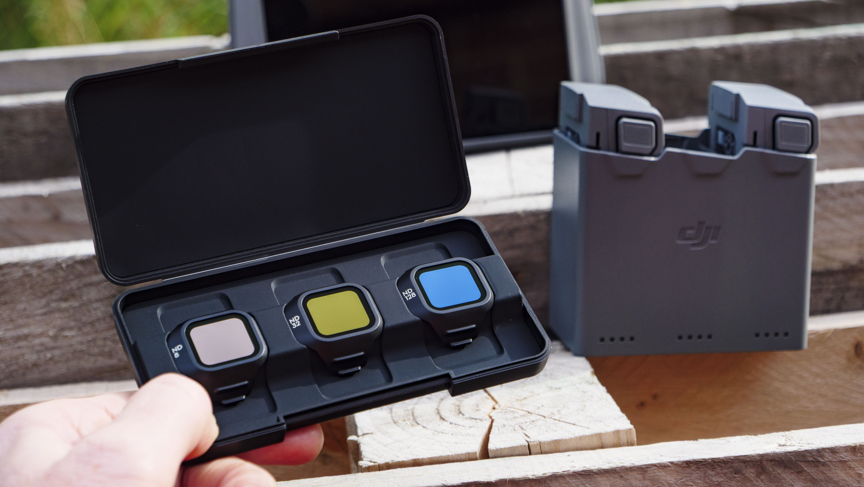 DJI Mini 5 Pro&#039;s ND filter set, with battery charging hub in the background