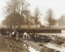 Workers dig out the moat at Oxburgh circa 1900-1910. ©National Trust