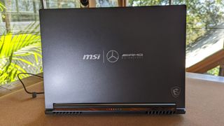 MSI Stealth 16 playing F1 on a yoga mat