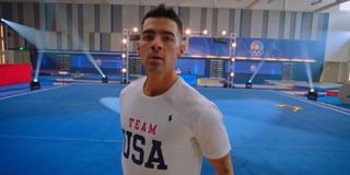 Joe Jonas landing his final move in this gymnastics floor routine on Olympic Dreams featuring Jonas Brothers
