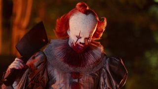 Pennywise with bloody face holding a hatchet in IT: Welcome to Derry finale