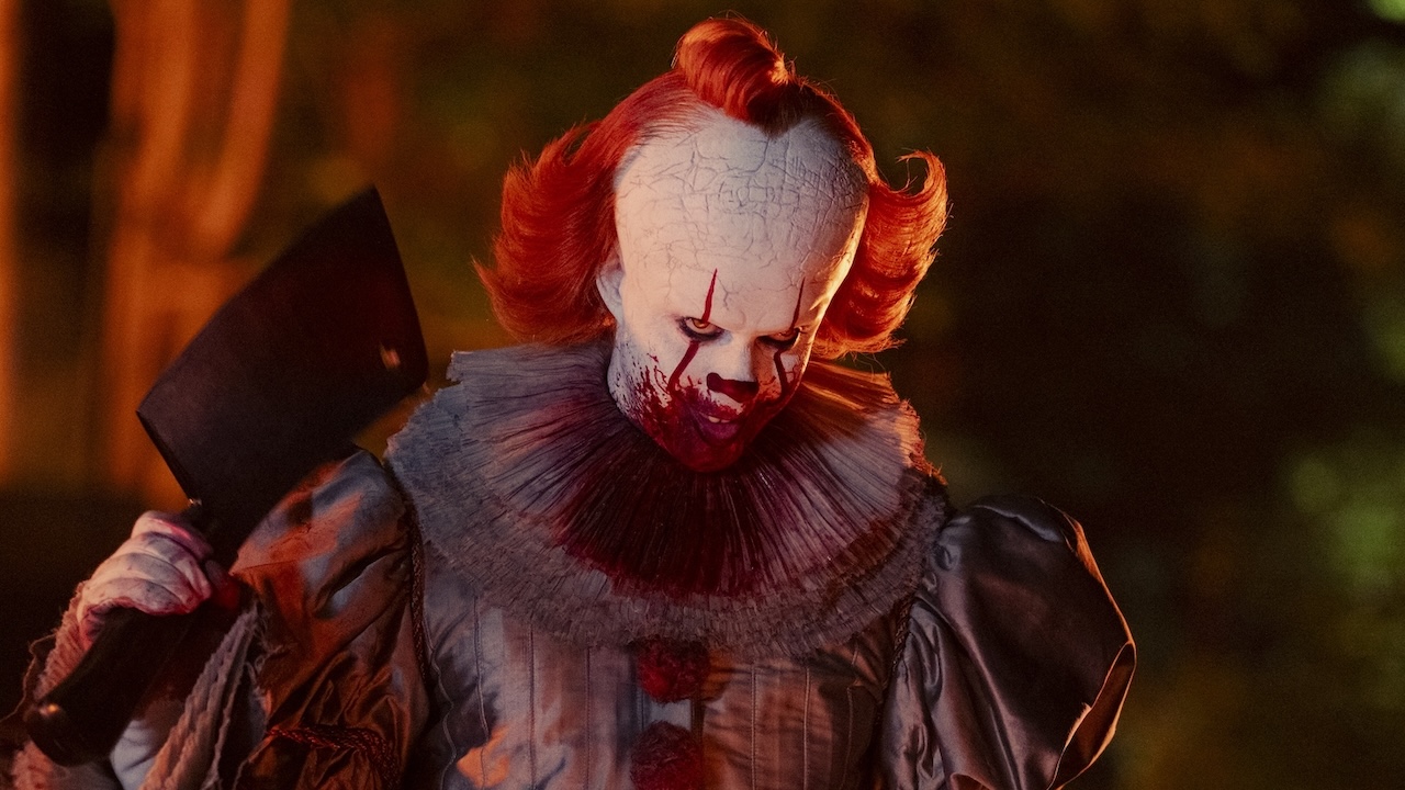 Pennywise with bloody face holding a hatchet in IT: Welcome to Derry finale