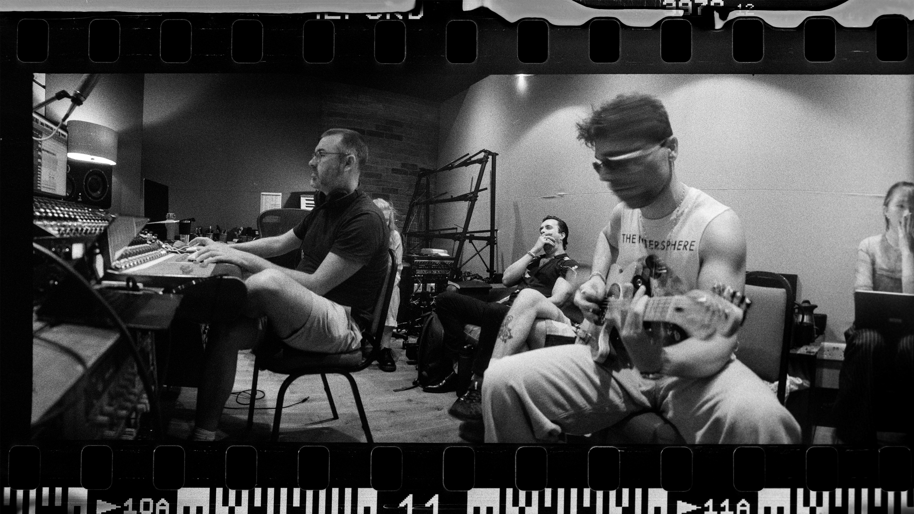 A band rehearsing in a studio.