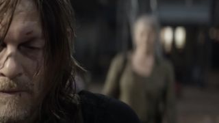 Close-up of Daryl's face as what appears to be Carol is standing out of focus behind him in The Walking Dead: Daryl Dixon - The Book of Carol