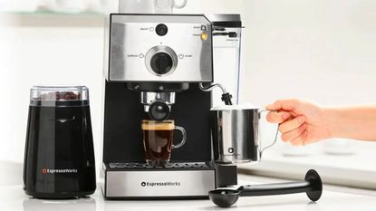 An Espresso Works All-In-One coffee machine in stainless steel making espresso