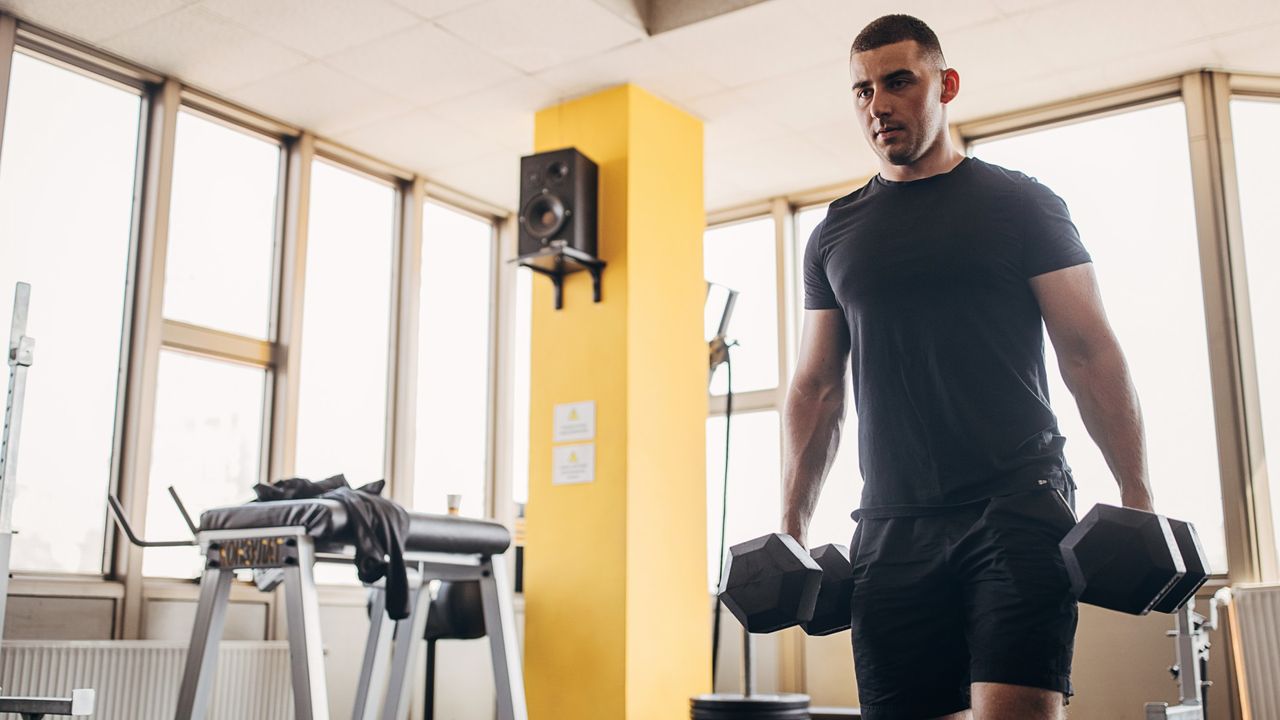 Man walking with dumbbells