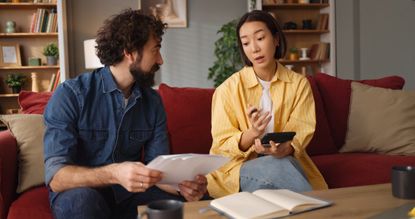 Couple discussing home finances managing budget and bills