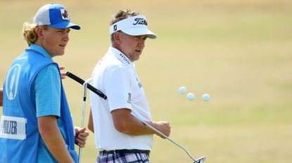 Ian Poulter of England looks on alongside their son and Caddie Luke Poulter during a practice round prior to The 150th Open at St Andrews