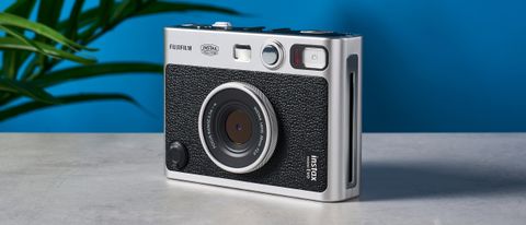 A black and gray Fujifilm Instax mini Evo hybrid instant camera