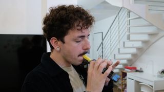 A man plays the Zefiro smartphone instrument attachment