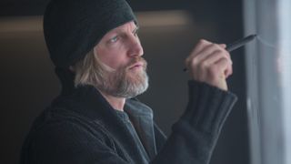 Haymitch draws on a board in The Hunger Games
