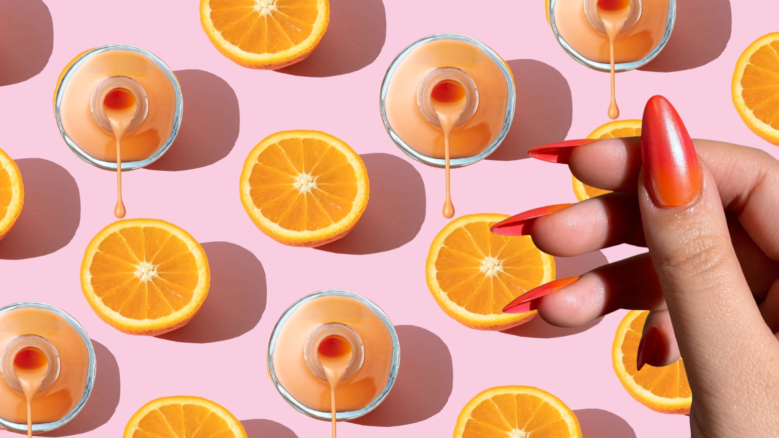 a pink background with oranges and a hand wearing orange nail polish