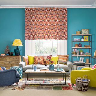 teal living room with yellow armchair and patterned blind