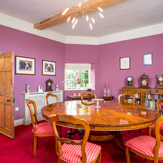 room with pink wall and wooden shelve