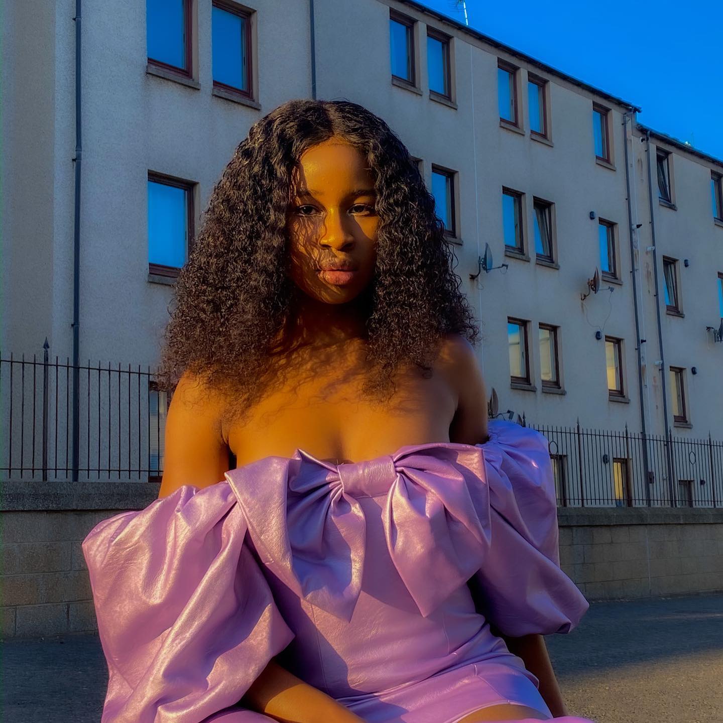 Girl with curly hair in purple dress