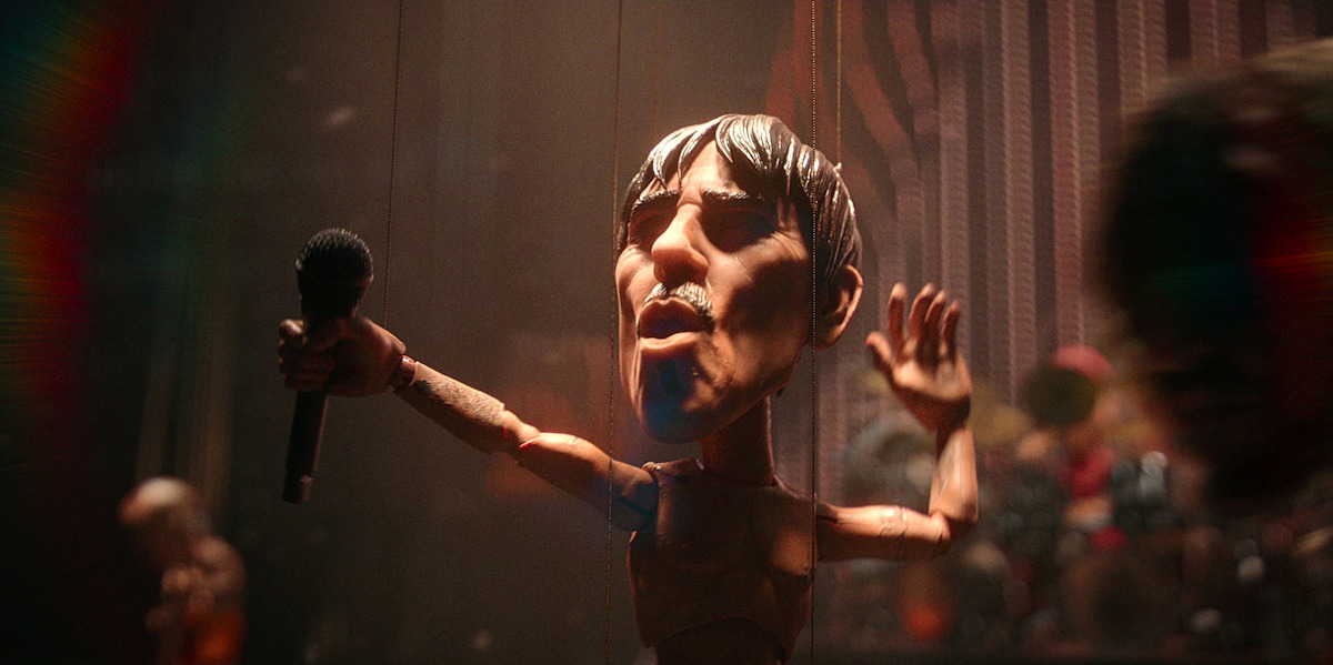 a marionette of a lead singer in a rock band