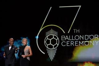 Ivorian former football player and evening host Didier Drogba (L) and French-British journalist and evening host Sandy Heribert speak on stage during the 2023 Ballon d'Or France Football award ceremony at the Theatre du Chatelet in Paris on October 30, 2023.