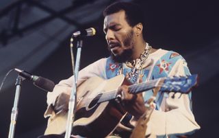 Richie Havens performs onstage at the Isle of Wight Festival on August 31, 1969
