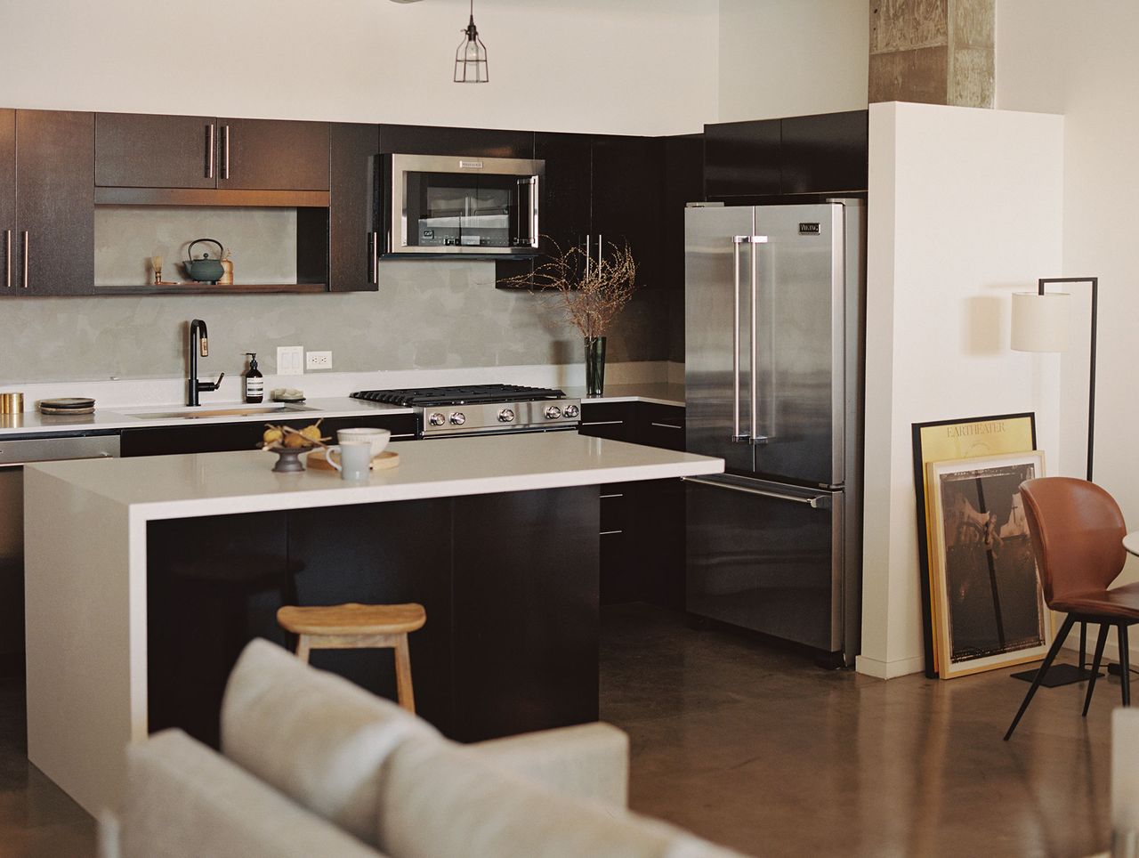 Barker Block kitchen with white countertops, island and dark cabinets