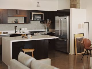 kitchen with white countertops, island and dark cabinets