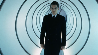 A still from the movie gattaca of ethan hawke walking down a long tunnel