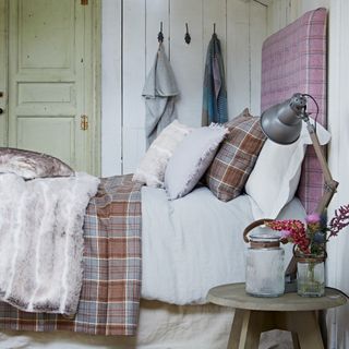 Tartan bedsheets in rustic looking bedroom