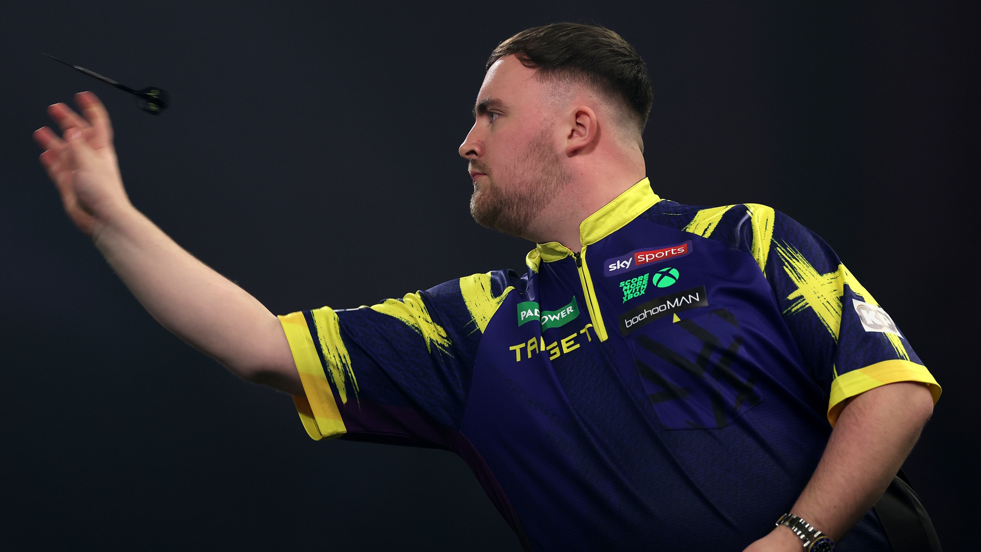 Luke Littler of throws a dart during a match.