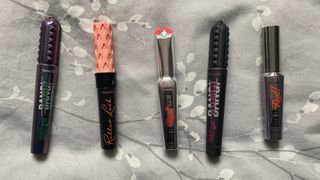Flatlay of Benefit Badgal BANG waterproof, Roller Lash, They're Real Magnet, Badgal BANG, and They're Real mascaras