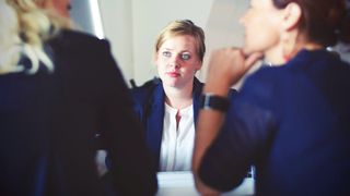 Three woman sitting at a desk