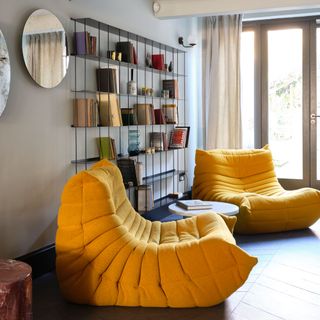 grey living room with yellow ligne roset togo armchairs