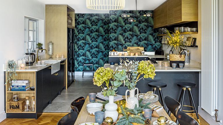 open-plan kitchen diner with botanical wallpaper oak wall cupboards and black base units