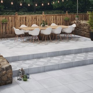 patio area with dining table and porcelain tiles