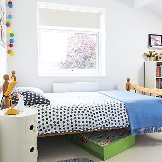 Child's bedroom with white wall and bed