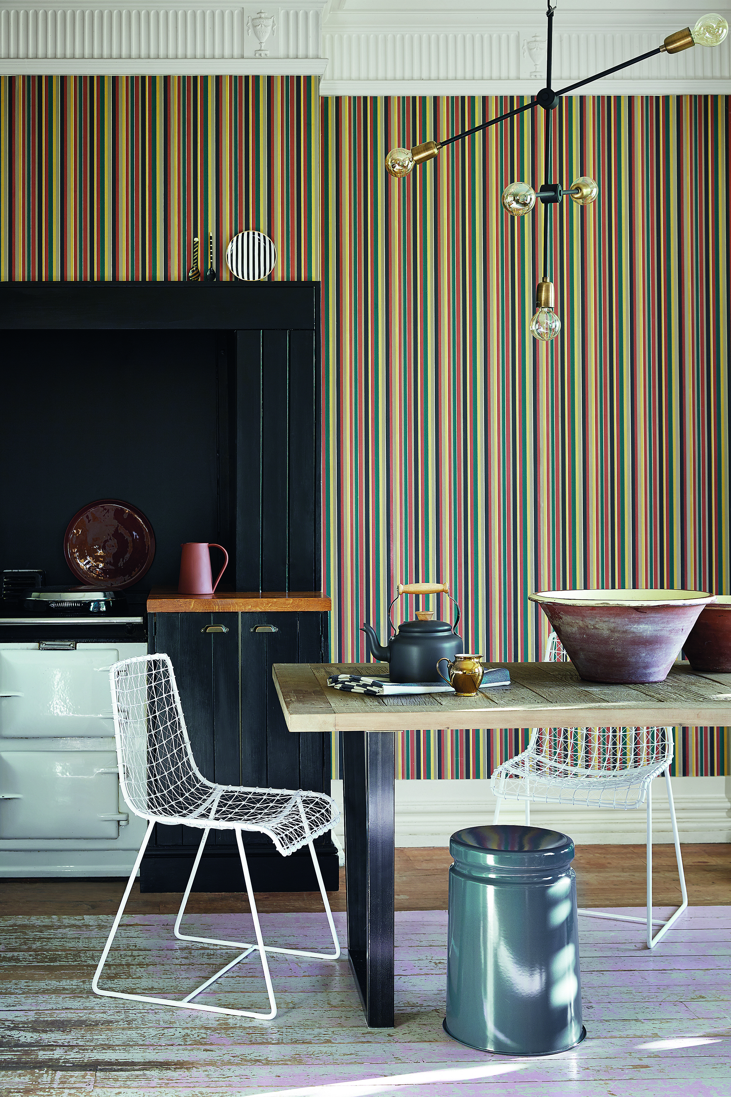 Stripped wallpaper with angular lantern, painted alcove space for white aga and wooden dining table