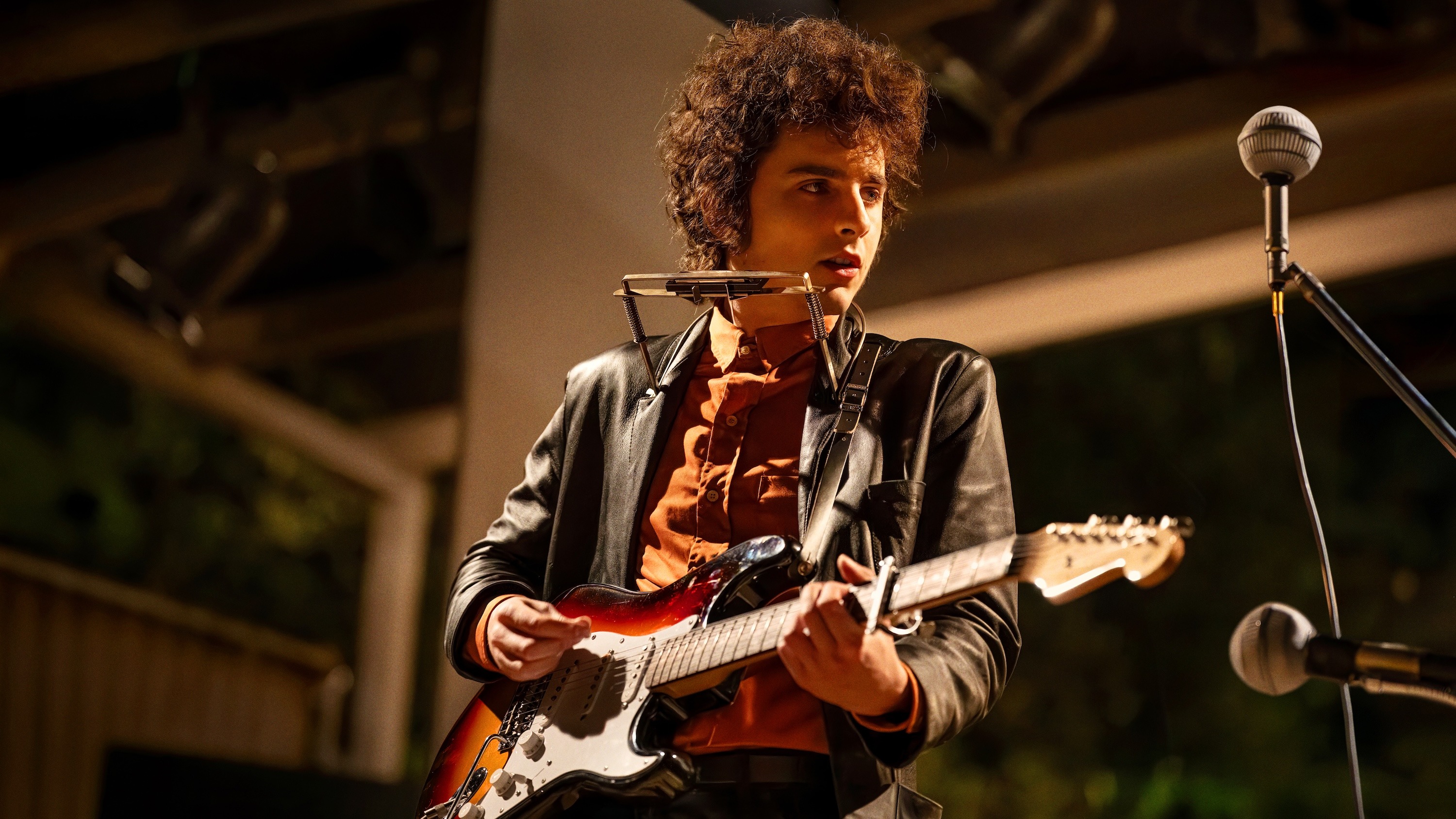 Timothee Chalamet playing guitar.