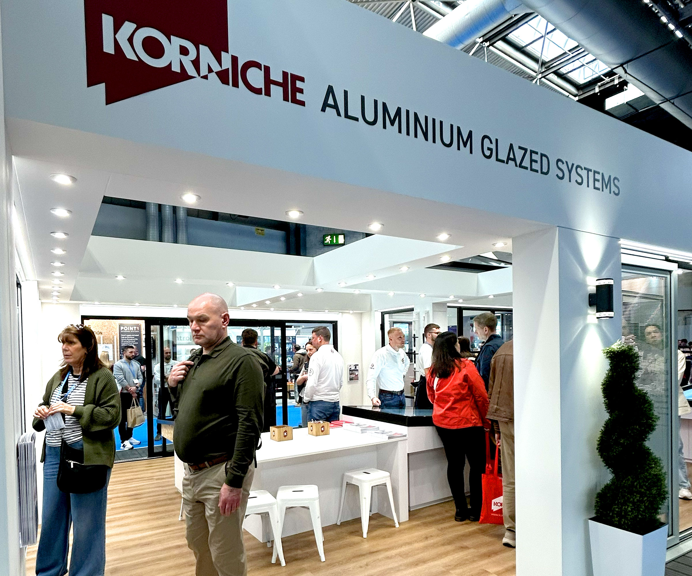 People walking around Korniche stand at HBR show talking to experts