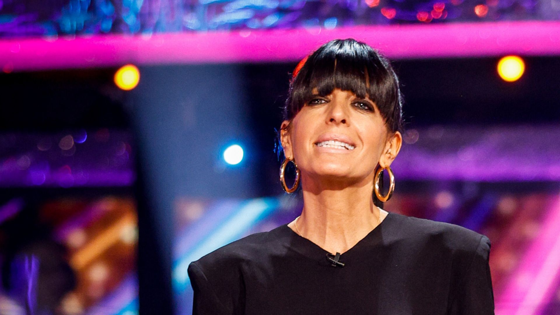 a headshot of claudia winkleman wearing black