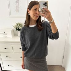 woman in gray crew neck sweater