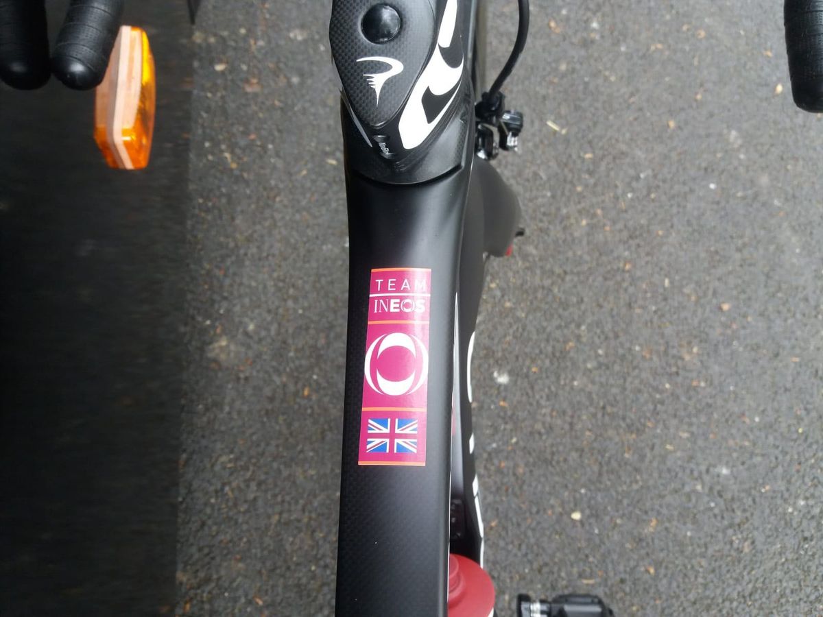 A Team Ineos sticker sits on the top tube of the bike