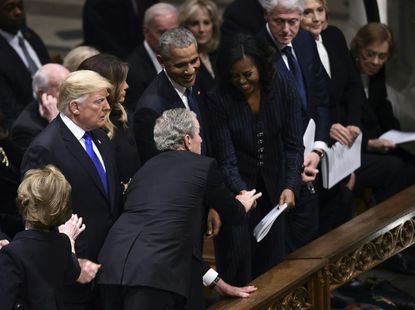 George W. Bush slips Michelle Obama a piece of candy
